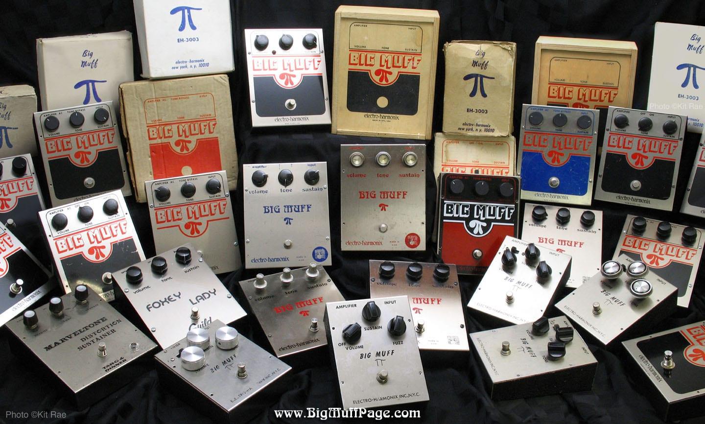 A collection of vintage Big Muff fuzz pedals arranged on a wall